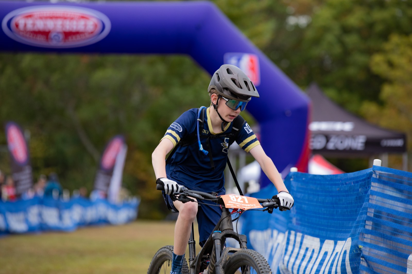 Young rider crossing under the Tennessee League finish arch