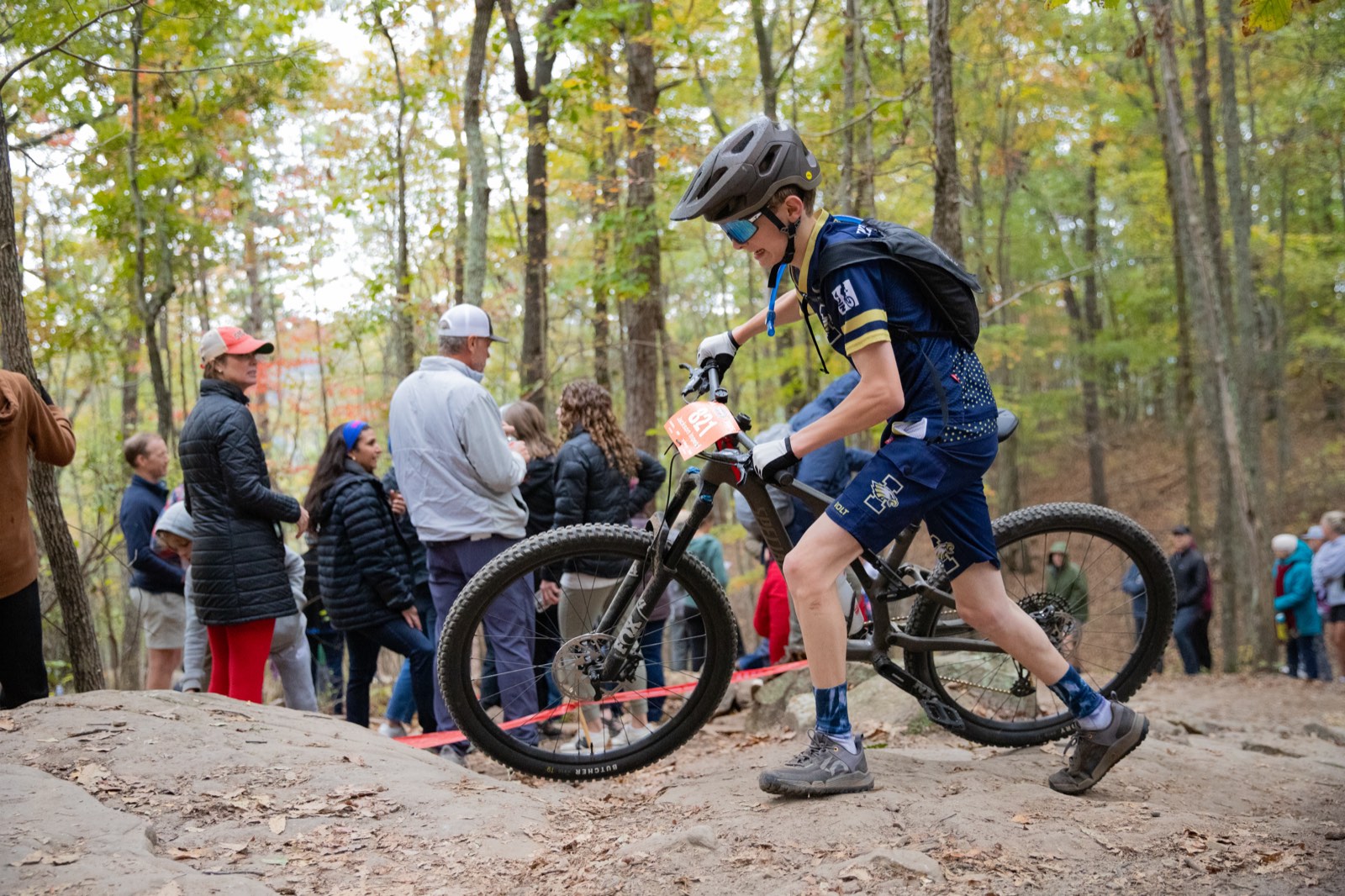 Rider working through a rock garden as spectators watch